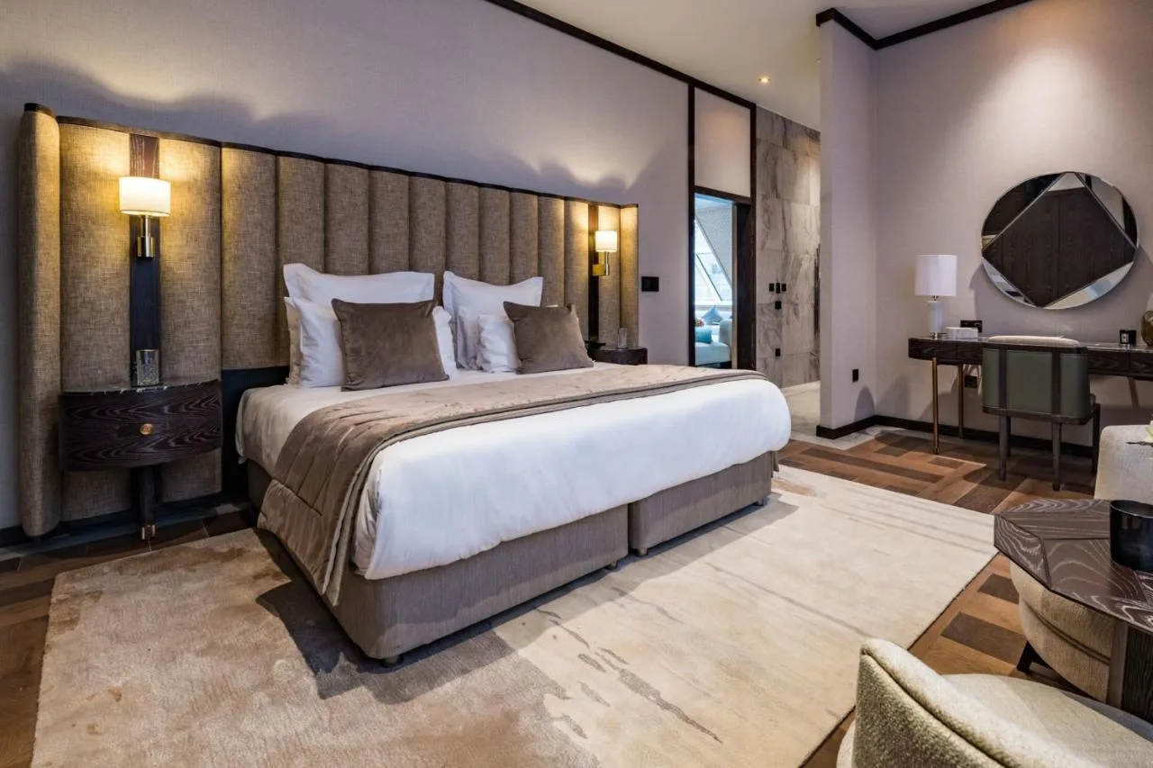 a bedroom with a large bed and a desk at Stock Exchange Hotel, Manchester, Autograph Collection in Manchester