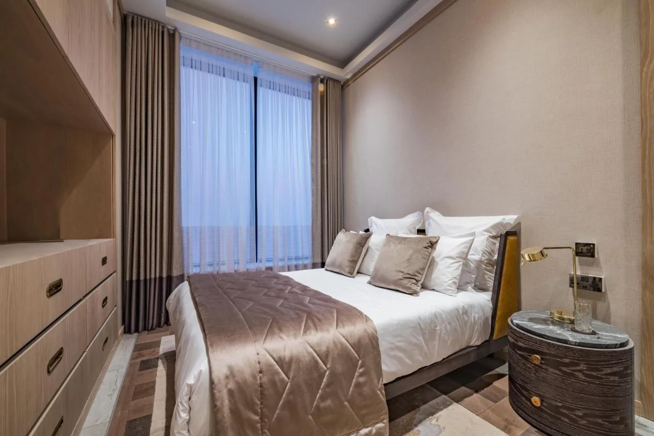 a bedroom with a bed and a large window at Stock Exchange Hotel, Manchester, Autograph Collection in Manchester
